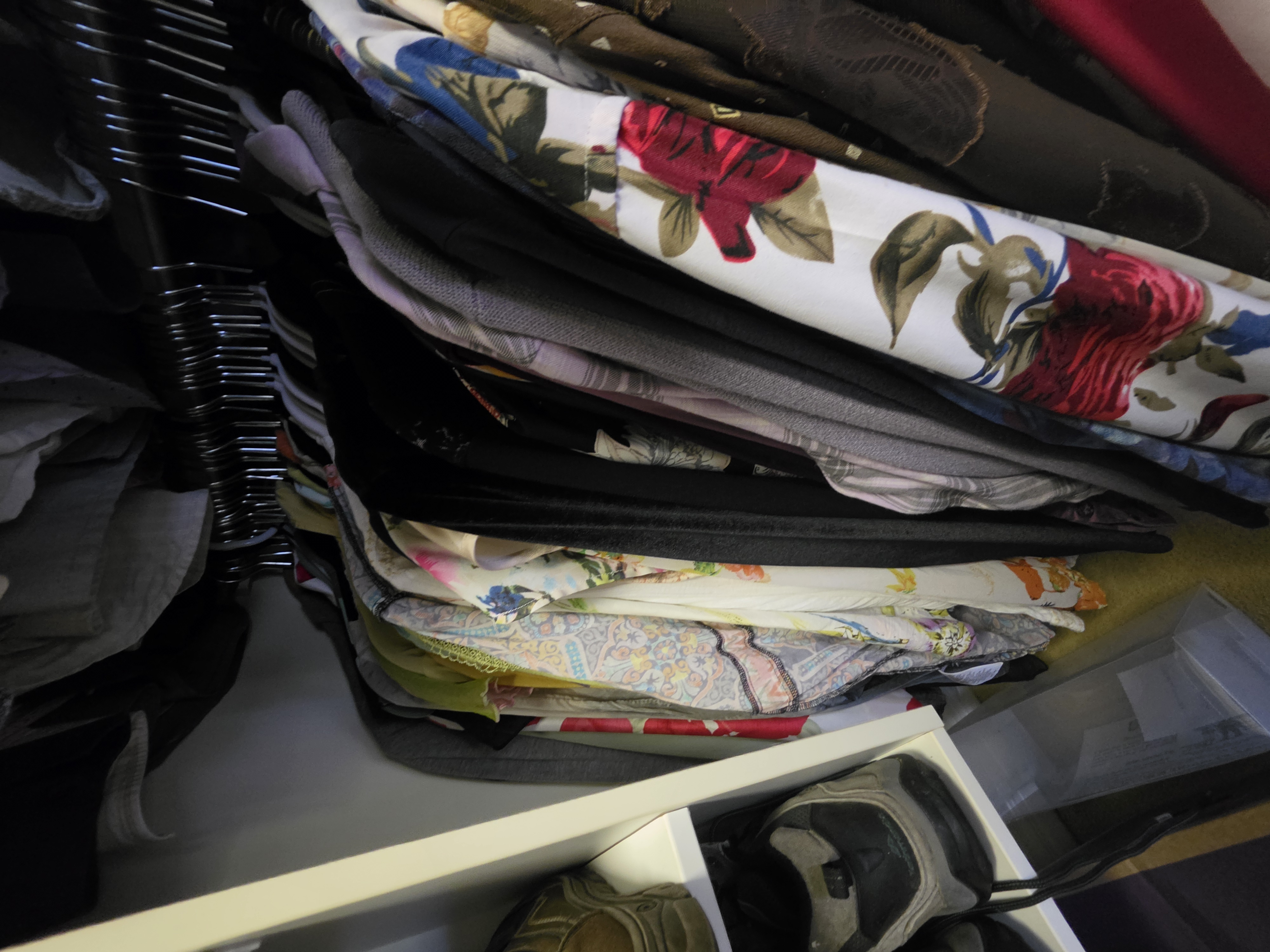 Shirts arranged along a wardrobe rail in practical colour groups
